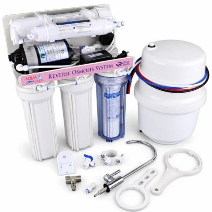Angled view of Aqua Cares RO purifier with clear housing, storage tank, faucet, wrenches and fittings