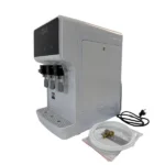 White countertop UF water purifier viewed from the side with water tubing and fittings