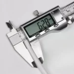 Digital caliper measuring the outside diameter of white P-DN6 PE water filter pipe