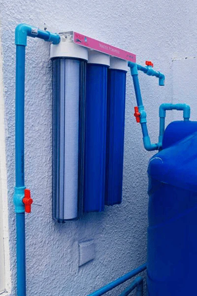 Three-stage 20-inch water filtration system connected to a household water tank