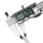 White PE water pipe with digital caliper displaying 6.28 mm